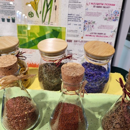 Jars of seeds, petals and dried plants – ingredients for handmade seed paper