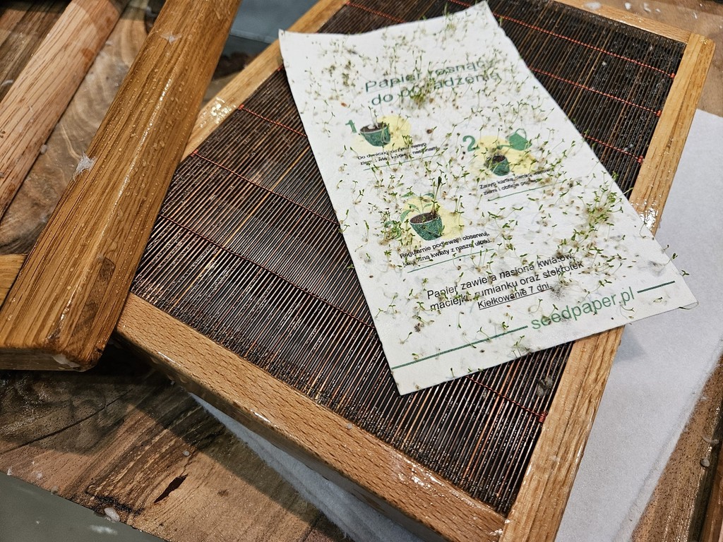 A sheet of seed paper printed with seedpaper.pl on a wooden laid papermaking mould