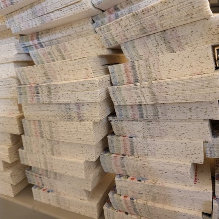 Stacks of cut seed paper cards ready for packing