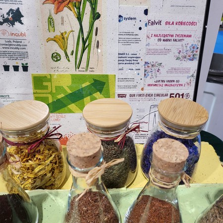 Jars of seeds and examples of printed plantable paper